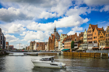 Fototapeta premium Beautiful city of Gdansk in the margins of the Motlawa river with the touristic boats and coloured buildings
