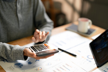 Close up woman hand using calculator. Doing finance, budgeting and tax calculation, monthly expenses