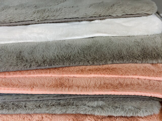 Experience the ultimate relaxation with our soft and cozy plush towels, beautifully stacked in an array of warm and inviting colors