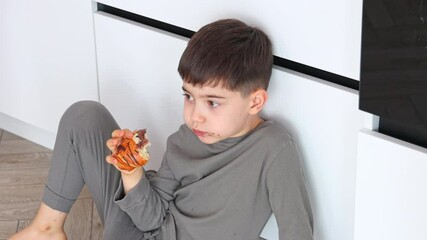 mom and sons sibling in kitchen in the morning eating croissant with chocolate,drinking tea. baby boy sitting on counter,mommy washing glass,sink in background.woman hugging kids, happy family