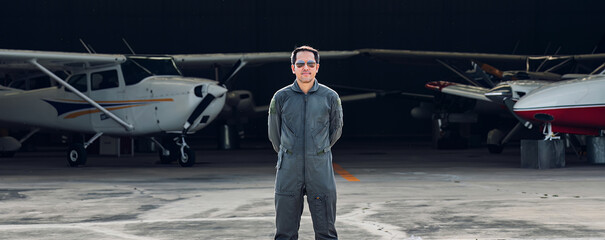 Pilot in uniform at airport. Asian Confident male pilot in uniform  and checking flight plan