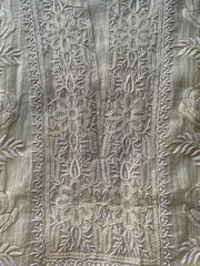 intricate white Chikankari floral design on white mul fabric delicately hand-embroidered of lucknow
