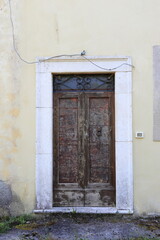 Old Wooden Door with Window Grill and Door Knocker in Central Italy Countryside Village