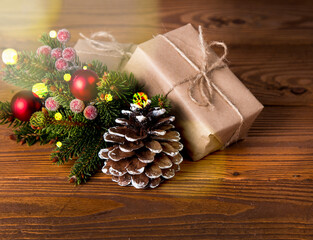Christmas decoration on wooden table. Celebration gift, pine cone and tree. 