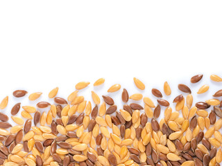 Golden and brown flax seed with copy space. Isolated one edge. Top view or flat lay