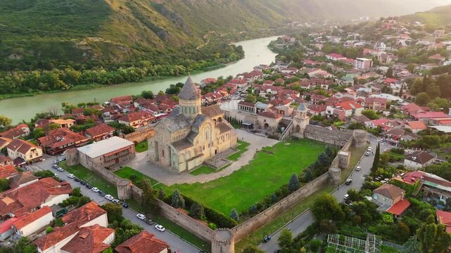 Aerial around view of great Svetitskhoveli Cathedral in Mtskheta, Georgia. Old Svetitskhoveli Church in center of Mtskheta village - UNESCO World Heritage