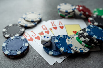 chips for poker with playing card on grey background, nobody