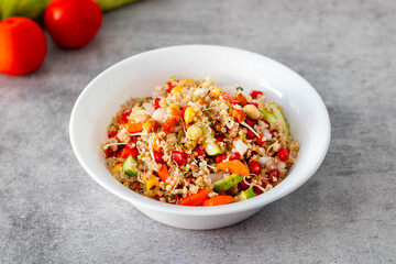 Vibrant Quinoa Salad with Fresh Vegetables, Tangy Citrus Dressing, Crunchy Nuts, Avocado, and a Zesty Herb Infusion.