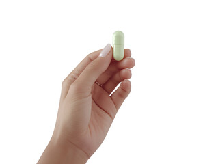 a hand holding a pill