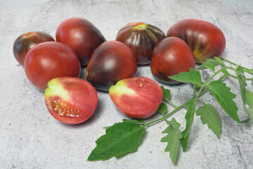 Red tomatoes, cut into several pieces, on a salad table.