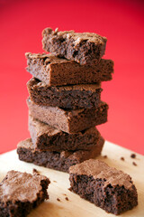 Classic Indulgence: Stacked Brownies on a Wooden Board