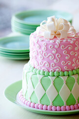 Tiered Pink and Light Green Cake on a Jadeite Plate