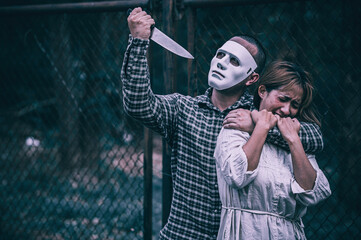 A serial killer scene is about to kill an Asian woman,concept thriller scene,Halloween festival
