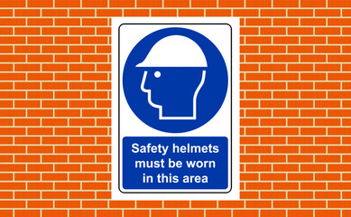 Obraz premium Safety helmets must be worn sign on a wall