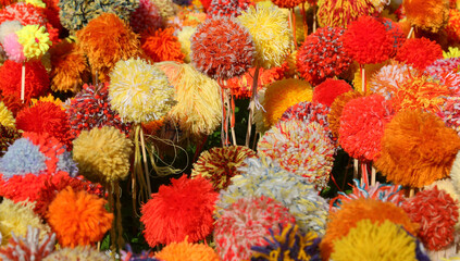 background of pom poms made with colorful wool threads that look like real flowers blooming in spring