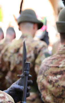 rifle with fixed bayonet of the Italian soldiers of the Alpine group with camouflage uniform