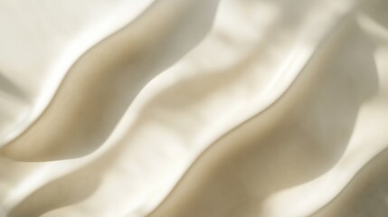 This image features abstract wavy patterns in soft beige and cream color tones, creating a smooth...