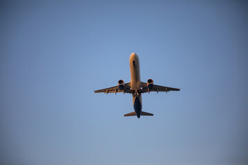 Beautiful airplane takes off at sunset. Sunny evening. Large passenger plane.