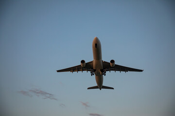 Beautiful airplane takes off at sunset. Sunny evening. Large passenger plane.
