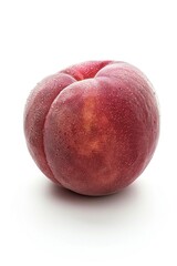 A ripe peach sits alone on a clean white surface, ideal for food or still life photography