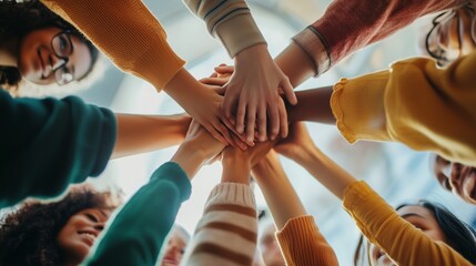 People joining hands in a circle during a community event indoors, showcasing unity and teamwork in a warm atmosphere