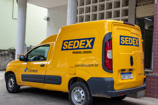 Yellow "Correios" van. Sedex and Correios logo on the car. Correios post office of Brazil logistics warehouse. Mail delivery car parked. 