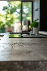 A person is working on a tablet computer placed on a wooden table