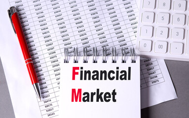 Financial market text on notebook with red pen, calculator, and numerical data sheet on grey desk
