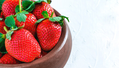 Fresh ripe strawberries in wooden bowl. Strawberry in bowl on oriental white background
