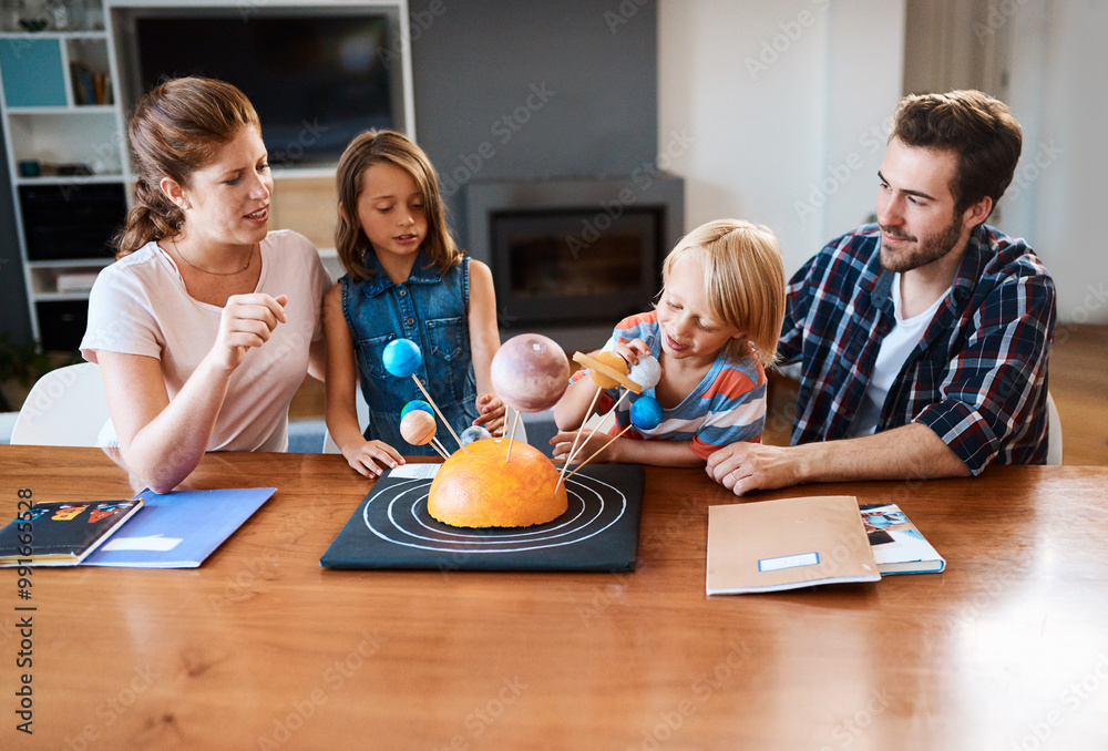 Wall mural Parents, children and science project for knowledge in home, building solar system and creativity. Family, support kids and kindergarten assignment on table, education and conversation on planets