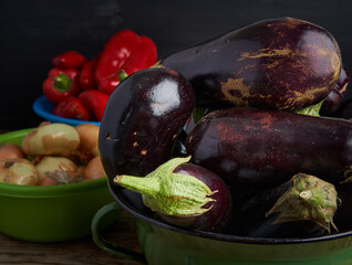 Raw organic eggplants, peppers and onions