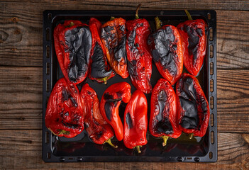 Grilled red peppers on wooden board