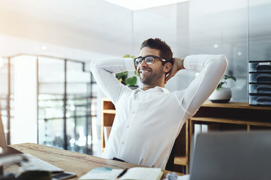 Businessman, happy and resting on computer at office with email notification for good news. Male person, employee and smile of satisfied with research results for project or task with relaxing