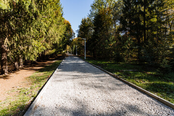 A beautiful scenic trail that winds through a lush, green forest featuring a charming gravel pathway inviting all to explore nature