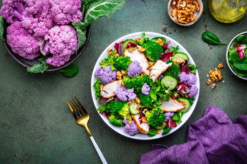 Healthy food salad with cauliflower, broccoli, chicken, cucumber, onion, radicchio, spinach with...