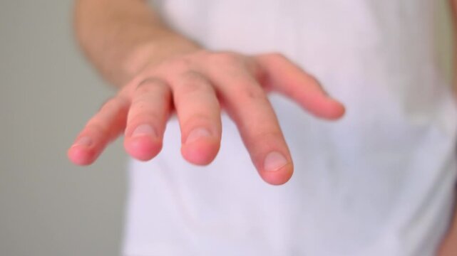 Close-up of man with hands and fingers shaking from stress