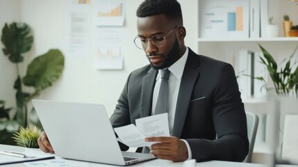 Obraz premium Marketer or analityc manager team dressed in suits working with paper charts and laptops at the white office interior