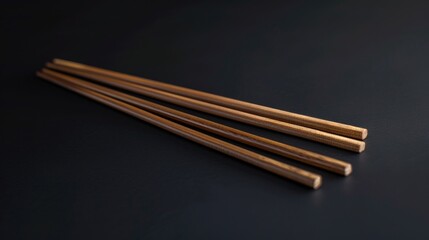 A pair of traditional Japanese chopsticks placed on a dark background