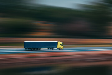 Truck with semi-trailer. Truck with a trailer is driving, blurred background