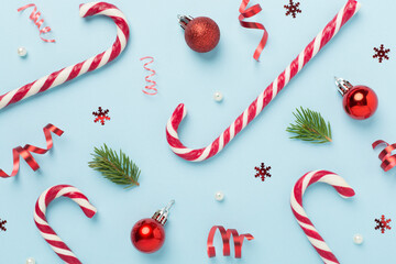 Christmas composition with lollipops on color background, top view