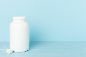 Jar with protein powder on table. Sports nutrition concept