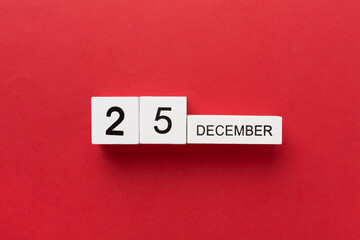Calendar with date December 25 on color background, top view