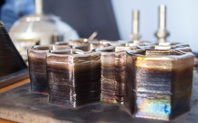 Object printed by 3D printer from metal. Additive manufacturing solution. Object created on 3Dprinter from melting metal thread. 3D Metal Printing. Metal additive manufacturing