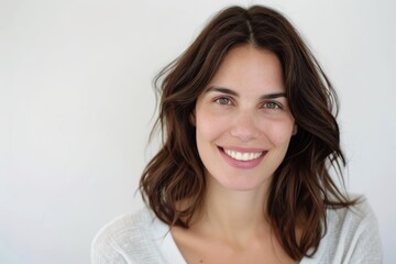 Naklejka premium : Elegant dark brown-haired woman portrait on white background, highlighting wellness.