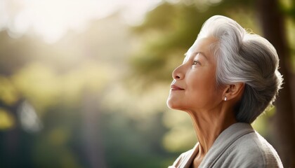 Japanese elderly woman breathing a fresh air in the park, meditation