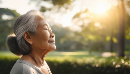 Japanese elderly woman breathing a fresh air in the park, meditation