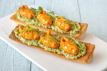 Guacamole toasts with crab claws