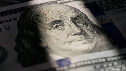 Close-up of a 100 dollar bill. The face of Benjamin Franklin. Macro