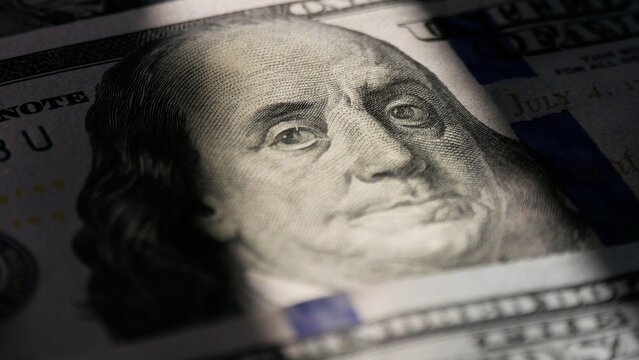 Close-up of a 100 dollar bill. The face of Benjamin Franklin. Macro