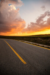 Sunset on Romania Transalpina road with many serpentines crossing forest in  Carpathian mountains. Mountains forest trees with road in Parang mountains